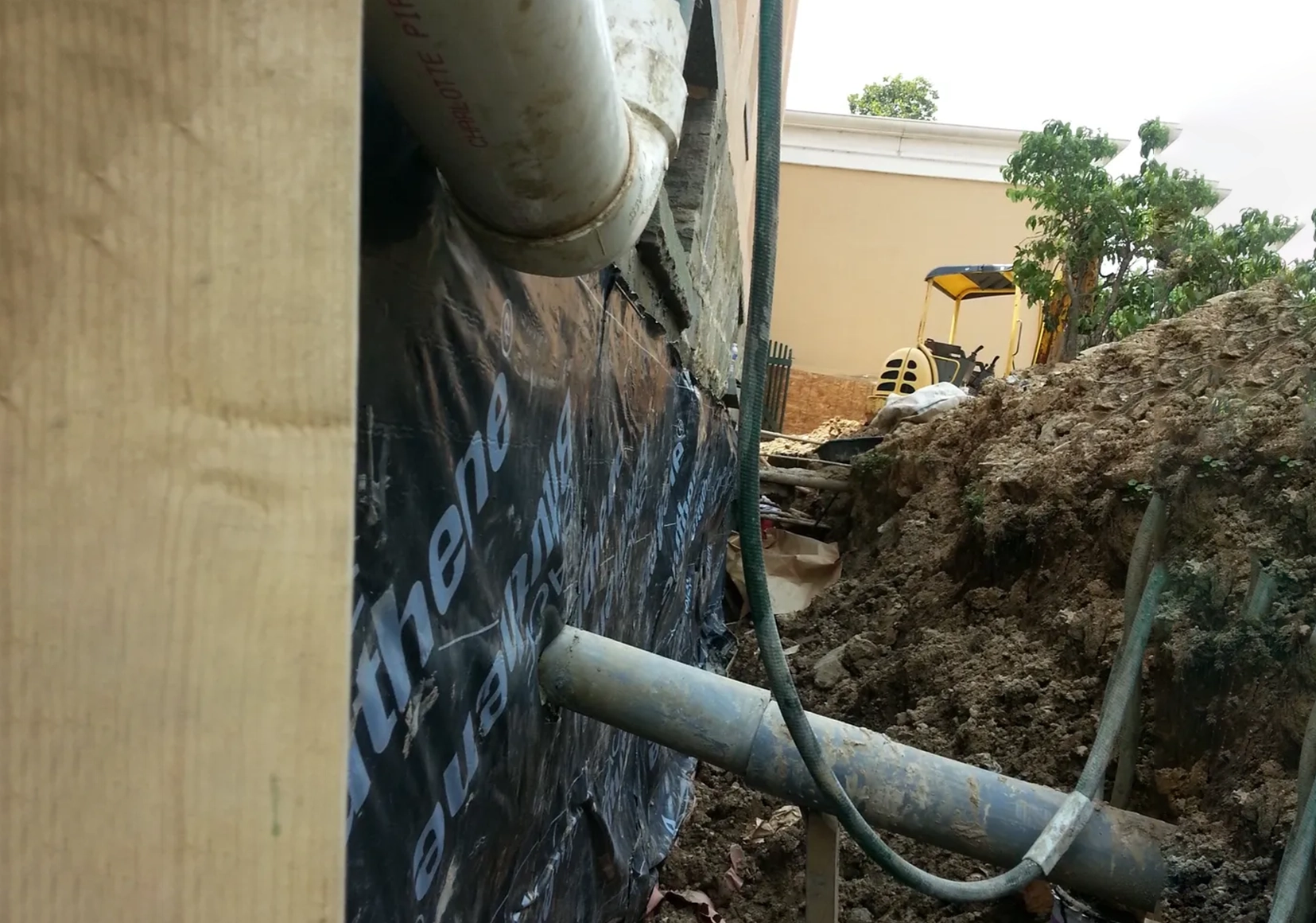 A pipe is attached to the side of a building.