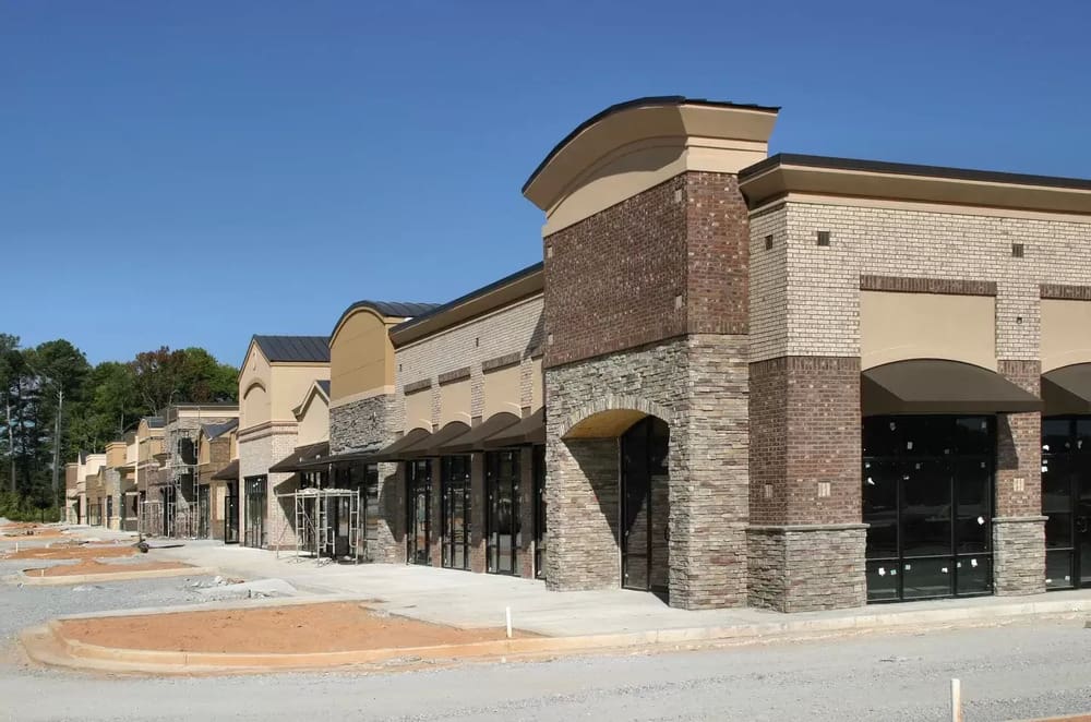 A large brick building with many windows on the side.