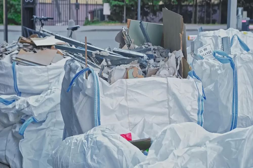 A pile of white bags filled with construction materials.