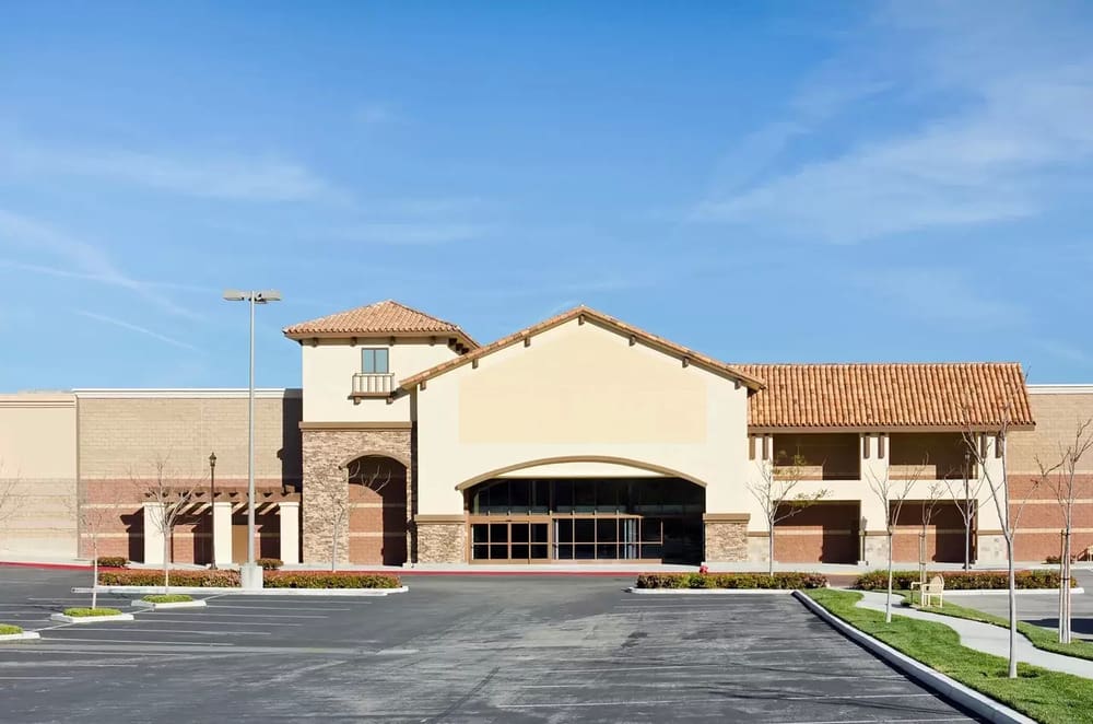 A large building with a parking lot in front of it.