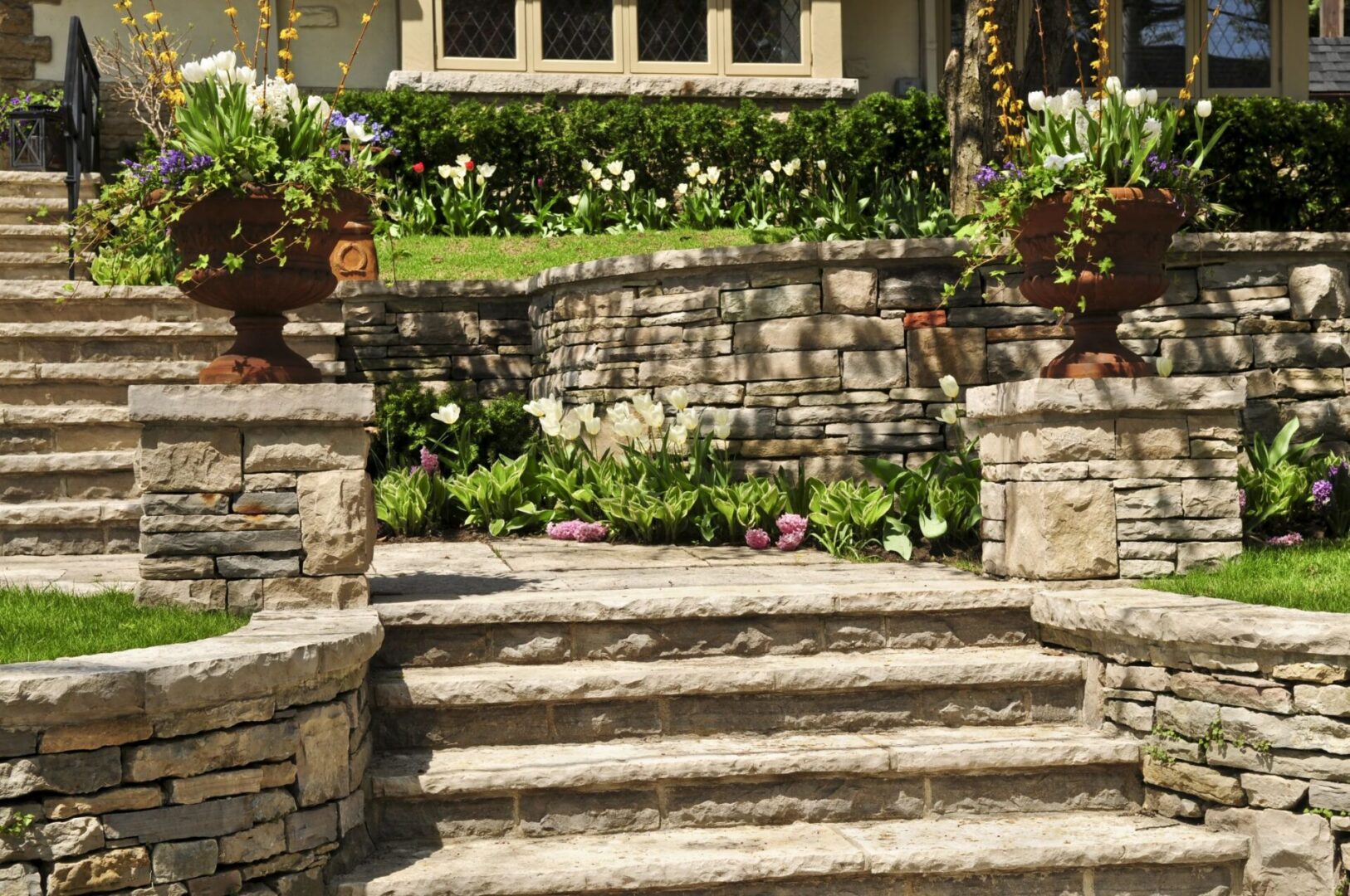 A stone staircase with plants growing on the side.