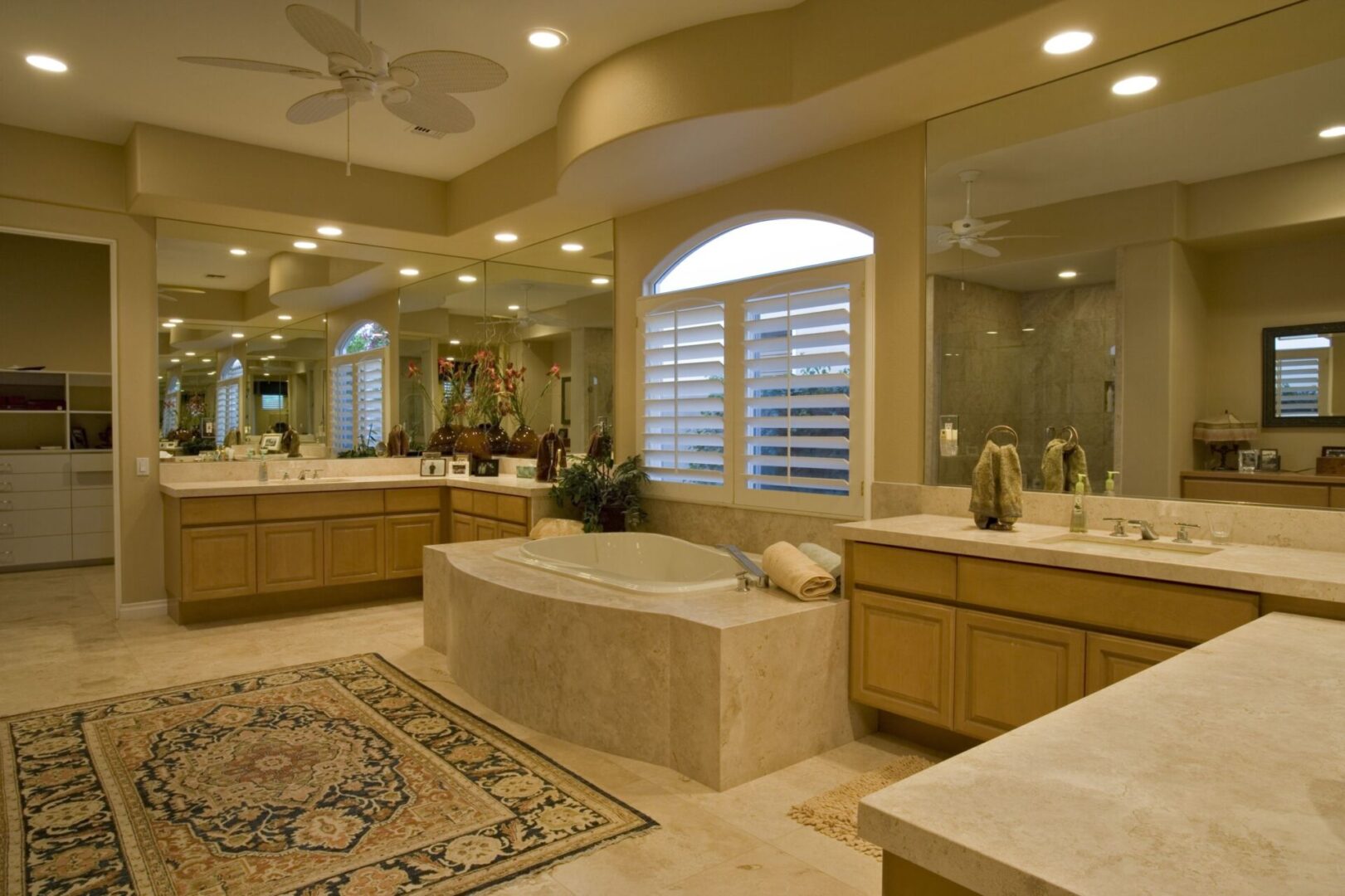 A large bathroom with a rug and two sinks.