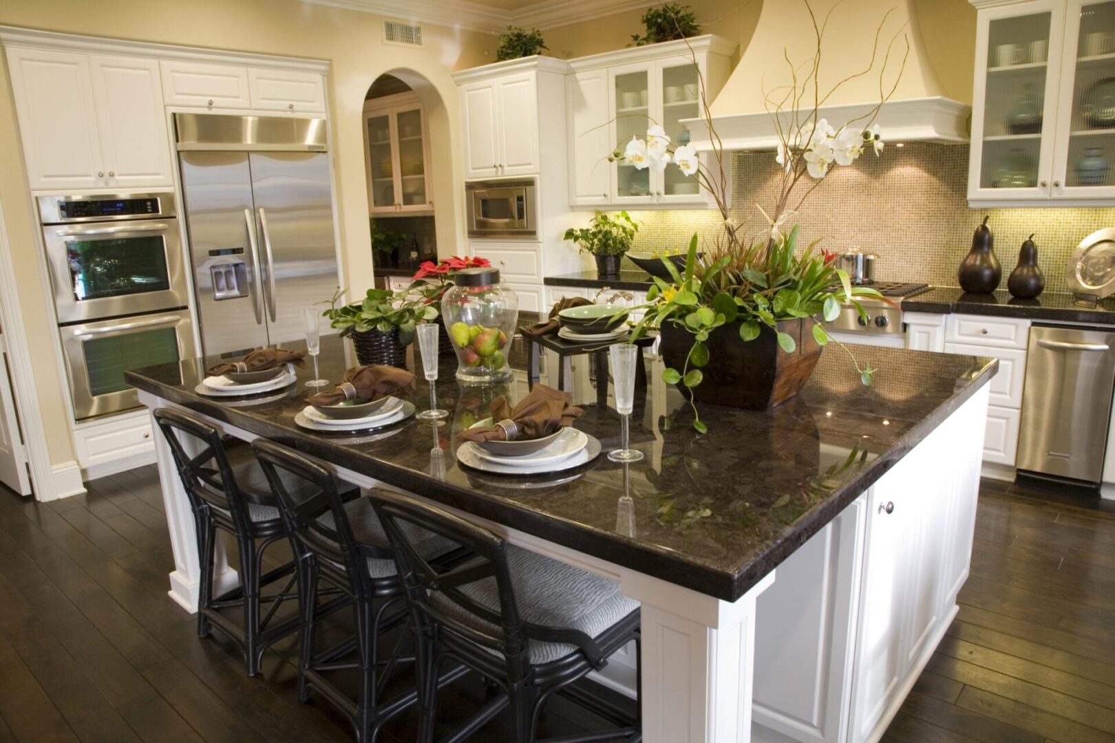 A kitchen with a large island and granite counter tops.