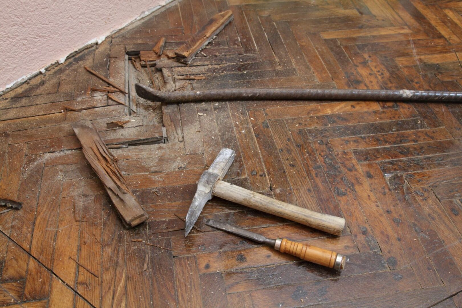 A hammer and two other tools on the floor.